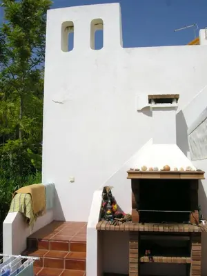 a outdoor pizza oven in a white building at Welcoming House in Albufeira in Albufeira