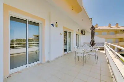 a patio with a table and chairs on a balcony at Falésia II - Nice Apartment - Vilamoura in Vilamoura