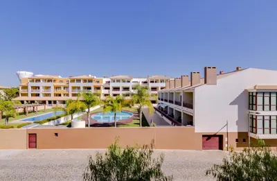 an aerial view of a resort with a pool and palm trees at Paraísos do Pinhal - 2 Bedrooms - Vilamoura in Vilamoura