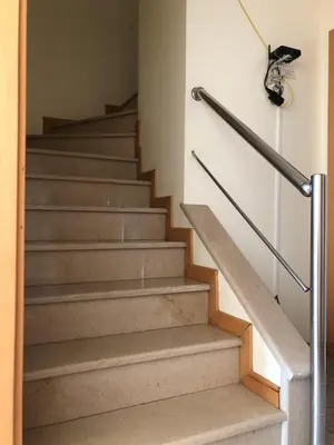 a set of stairs in a building at Apartamentos Pomba Branca in Olhos de Água