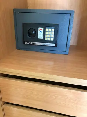 a small tv sitting on top of a wooden drawer at Apartamentos Pomba Branca in Olhos de Água