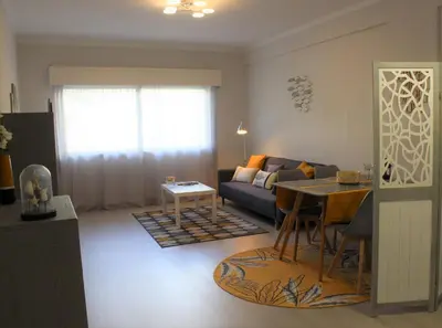 a living room with a couch and a table at Paz na Areia in Quarteira