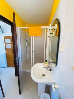 a bathroom with a white sink and a shower at Eucalipto in Faro