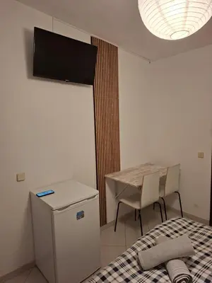 a room with a bed and a table and a television at Eucalipto in Faro