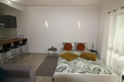 a bedroom with a bed with two pillows on it at Apartamento T0 Albufeira perto do Centro in Albufeira