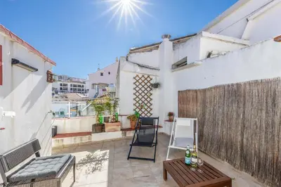 a patio with a chair and a table on a balcony at Townhouse N7 - Albufeira in Albufeira