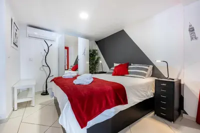 a bedroom with a large bed with a red blanket at Townhouse N7 - Albufeira in Albufeira