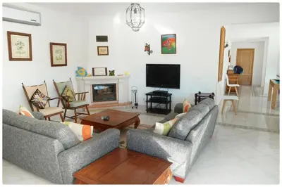 a living room with two couches and a tv at Casa do Mar by Laranjal Rentals in Albufeira