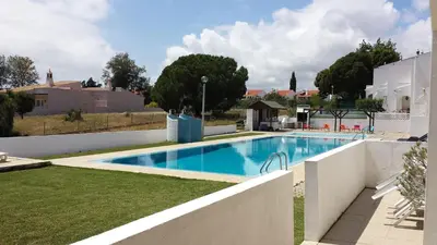 a swimming pool in the yard of a house at Vila Olímpica in Albufeira