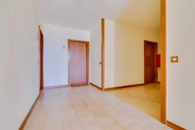an empty hallway with two doors and a tile floor at Sunset Bacara - Near Vilamoura Marina in Vilamoura