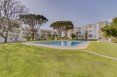 a swimming pool in front of a building at Pinhal do Golfe - 2 Bedrooms - Vilamoura in Vilamoura