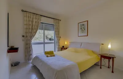 a bedroom with a yellow bed and a window at Pinhal do Golfe - 2 Bedrooms - Vilamoura in Vilamoura