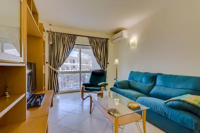 a garage door in a white building with plants at Pinhal do Golfe - 2 Bedrooms - Vilamoura in Vilamoura