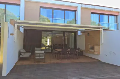 a house with a patio with a table and chairs at Villa Dolce Vita CD 81 - Clever Details in Vilamoura