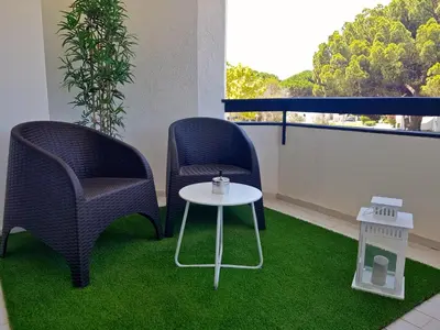 two chairs and a table on a balcony at Ténis Golf Mar CD 14 - Clever Details in Vilamoura