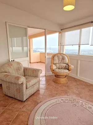 a living room with two chairs and a chair and a couch at Elegant family house in Loulé with private pool in Loulé