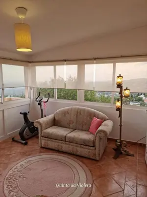 a living room with a couch and some windows at Elegant family house in Loulé with private pool in Loulé