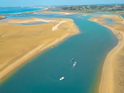 two boats in the water on the beach at Apartment Ipanema 3 by Algarve Vacation in Albufeira