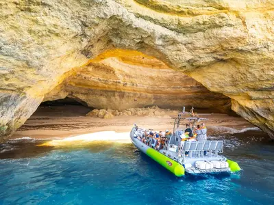 a group of people on a boat in front of a cave at Apartment Ipanema 3 by Algarve Vacation in Albufeira