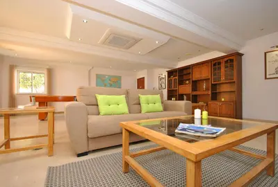 a living room with a couch and a table at Villa Nespereira by Algarve Vacation in Albufeira
