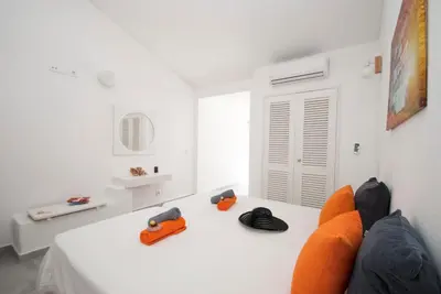 a living room with an orange couch and a white table at Villa São Paulo by Algarve Vacation in Albufeira