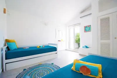 a bedroom with two beds and a window at Villa São Paulo by Algarve Vacation in Albufeira