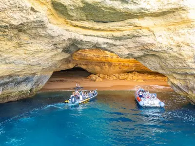 two boats in the water in front of a cave at Villa São Paulo by Algarve Vacation in Albufeira