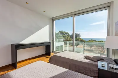 a bedroom with two beds and a large window at Villa Ocean Pine in Albufeira