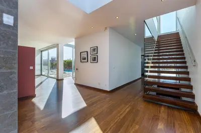 a staircase in a house with glass walls at Villa Ocean Pine in Albufeira