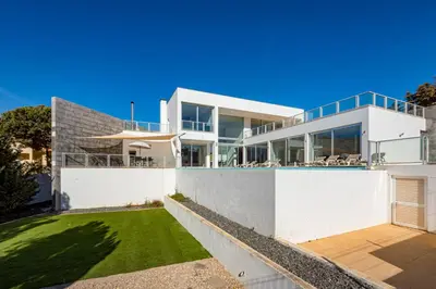 a large white house with a lawn in front of it at Villa Ocean Pine in Albufeira