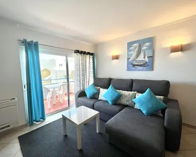 a living room with a couch and a table at Mar apartment wonderful view - Quarteira in Quarteira