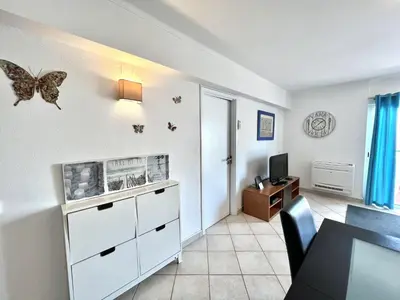 a living room with a butterfly on the wall at Mar apartment wonderful view - Quarteira in Quarteira