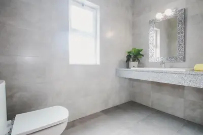 a bathroom with a toilet and a sink and a mirror at Villa Honolulu by Algarve Vacation in Albufeira