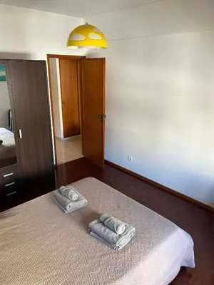 a dining room table with two chairs and a bed at CASA JUDITE in Faro