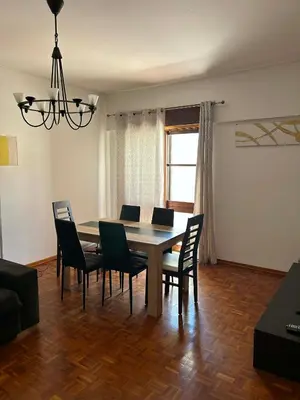a living room with a couch and a window at CASA JUDITE in Faro