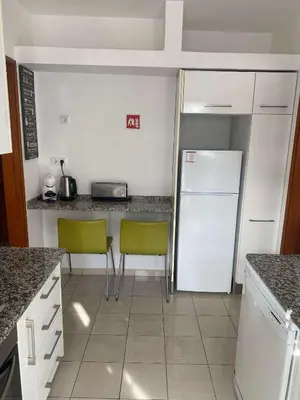 a kitchen with a sink and a washing machine at CASA JUDITE in Faro