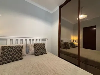 a bedroom with a large mirror and a bed at The Marina Plaza Vilamoura in Vilamoura