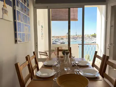 a dining room table with a view of the ocean at The Marina Plaza Vilamoura in Vilamoura