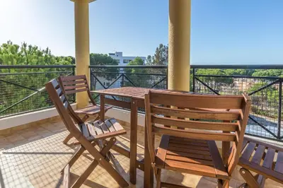 two chairs and a table on a balcony with a view at Modern Top Floor Apartment 60m2 - Balcony with Pool & Sea View - Vilamoura in Vilamoura