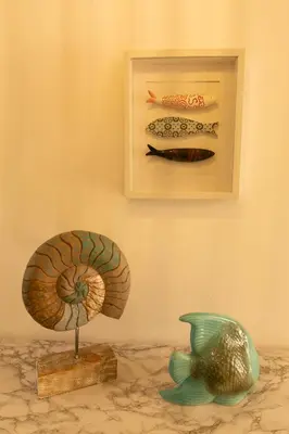 two sculptures of a shell and a fish on a wall at Sunny Condo-Pool by Algarve Dream Holidays in Albufeira