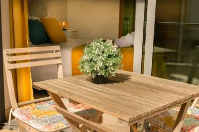 a wooden table with a potted plant on it at Sunny Condo-Pool by Algarve Dream Holidays in Albufeira