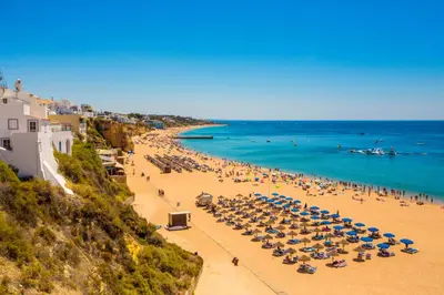 a swimming pool in a resort with chairs and trees at Sunny Condo-Pool by Algarve Dream Holidays in Albufeira