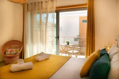 a bedroom with a bed with two towels on it at Sunny Condo-Pool by Algarve Dream Holidays in Albufeira