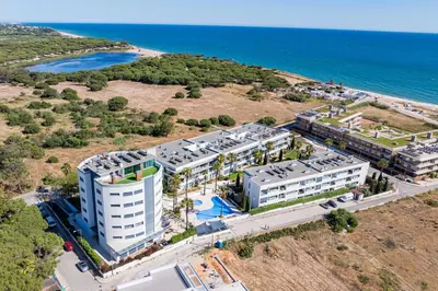 an aerial view of a building next to the ocean at Cavalo Preto Luxury Beach Apartment by Golden Zenith in Quarteira