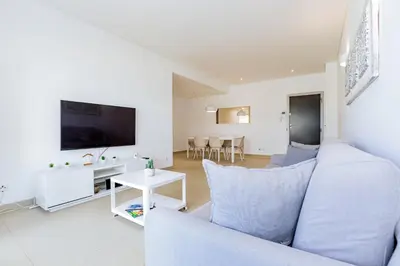 a living room with a couch and a tv at Cavalo Preto Luxury Beach Apartment by Golden Zenith in Quarteira