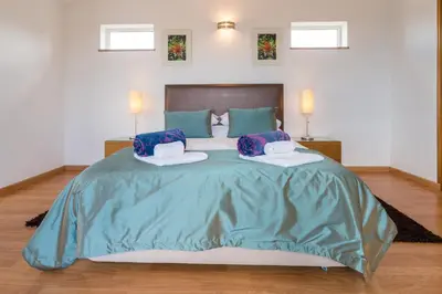 a bedroom with a large bed with two pillows at Casa Laranja Three bedroom Villa in Loulé