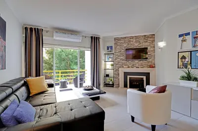 a living room with a couch and a fireplace at Vilamoura Design 1 with Pool by Homing in Vilamoura