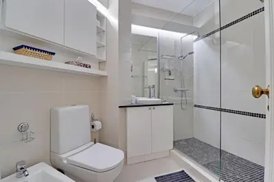 a white bathroom with a toilet and a shower at Vilamoura Design 1 with Pool by Homing in Vilamoura