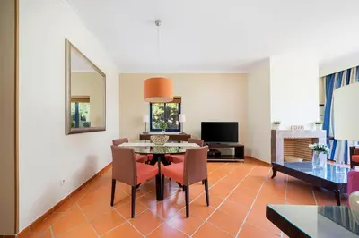 a living room with a table and chairs at AL - Apartamento Vila Sol F5 Top Floor in Quarteira
