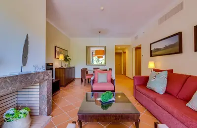 a living room with a red couch and a fireplace at AL - Apartamento Vila Sol F5 Top Floor in Quarteira